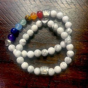 Set of two beaded bracelets with heart and dog paw charms.